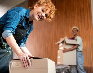 couple with cardboard boxes their new home ()