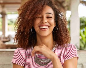 headshot glad woman laughs smiles broadly ()