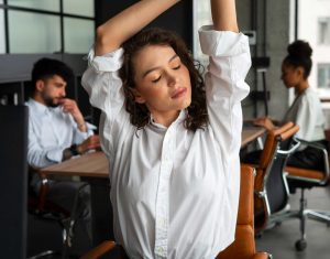 medium shot woman stretching work ok JPBEBV ()